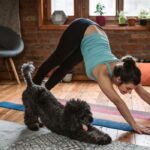 Woman doing yoga with her dog
