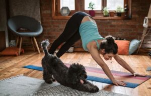 Woman doing yoga with her dog