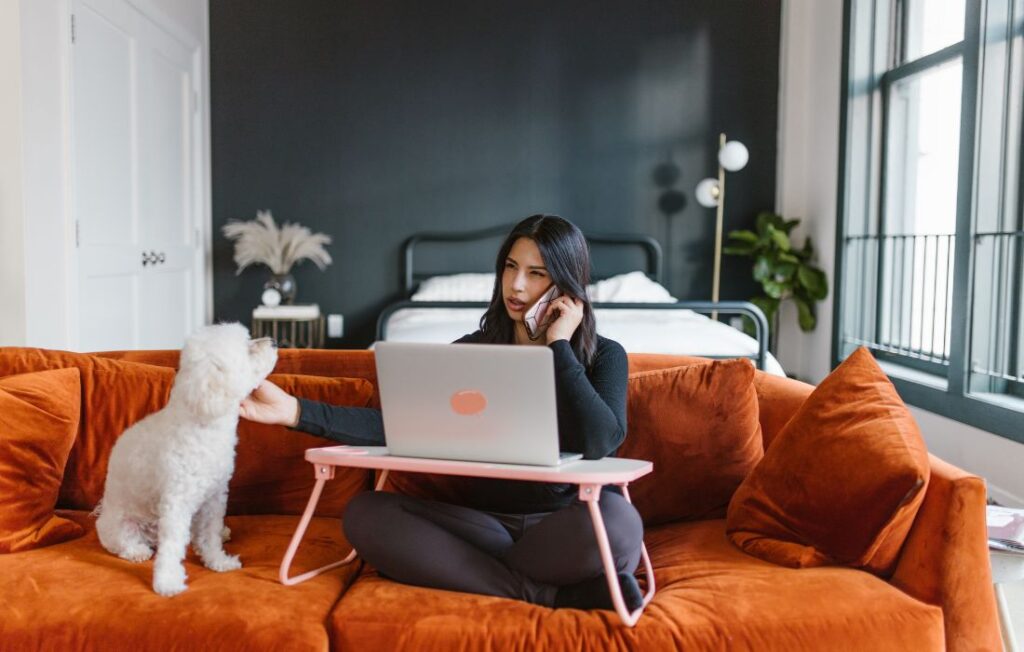 Woman Petting a Dog While on Phone Call
