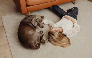 black dog and girl on rug