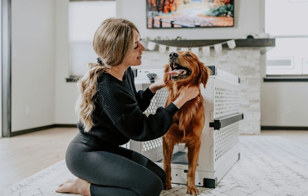 woman crate training a dog