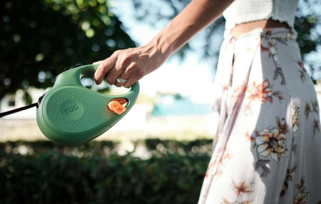 woman holding dog leash