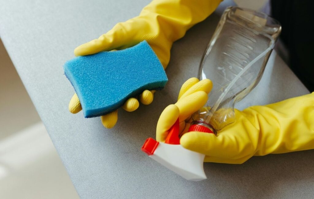 hands cleaning with sponge and spray bottle