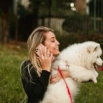 Woman Holding a White Dog