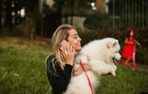 Woman Holding a White Dog