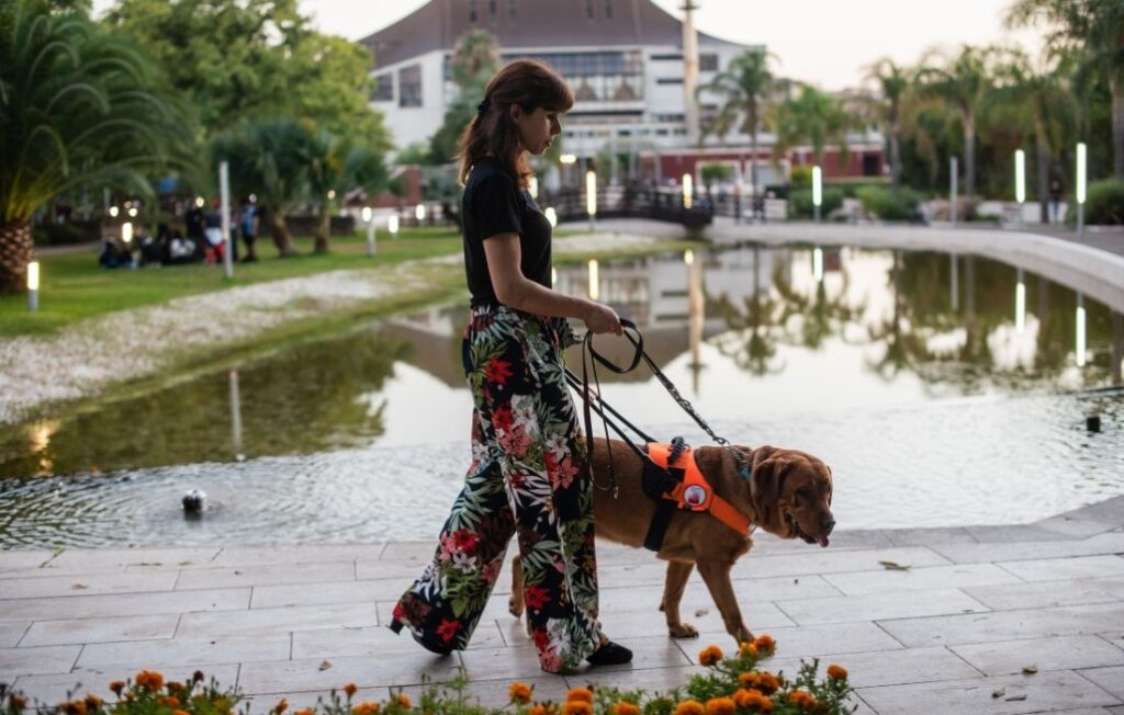 Woman with Service Dog Walking by the Pond