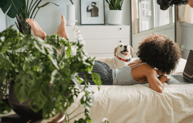 black woman with dog and laptop