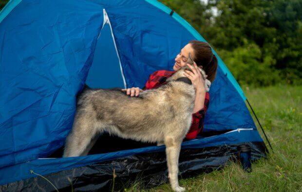 girl camping with dog